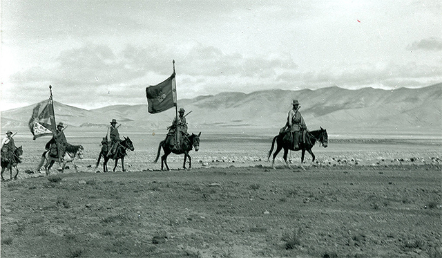 Tibetan soldiers on horseback carrying the national flag and the double vajra army flag. Photographer unknown, circa 1945.